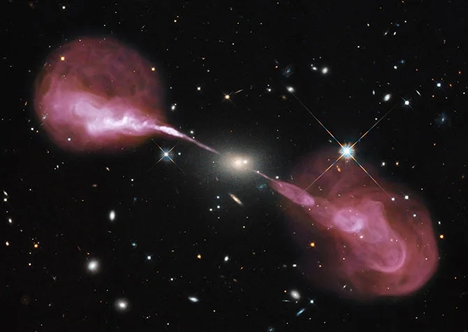 composite picture of the Hercules A Galaxy, as well as the Active Galactic Nucleus within it and its jets, which expand for over a million light years.